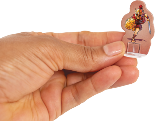 Hand holding a small figurine with a character on a white background