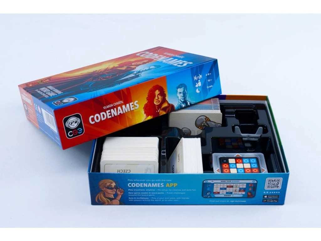 Open box of Codenames game with colorful packaging on a white background