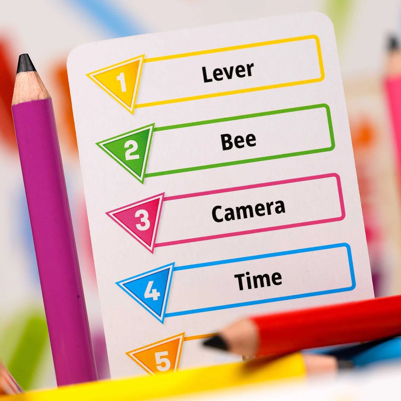 Sheet of paper with colorful labels and a pencil on a blurred background
