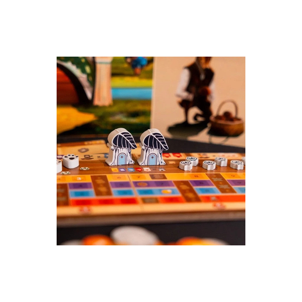 Two small figurines on a board game with colorful tiles and pieces.