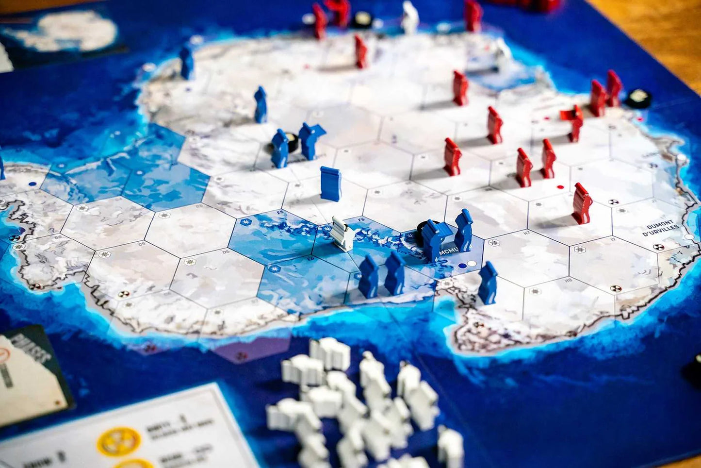 Board game with map of Antarctica and player pieces on a blue board