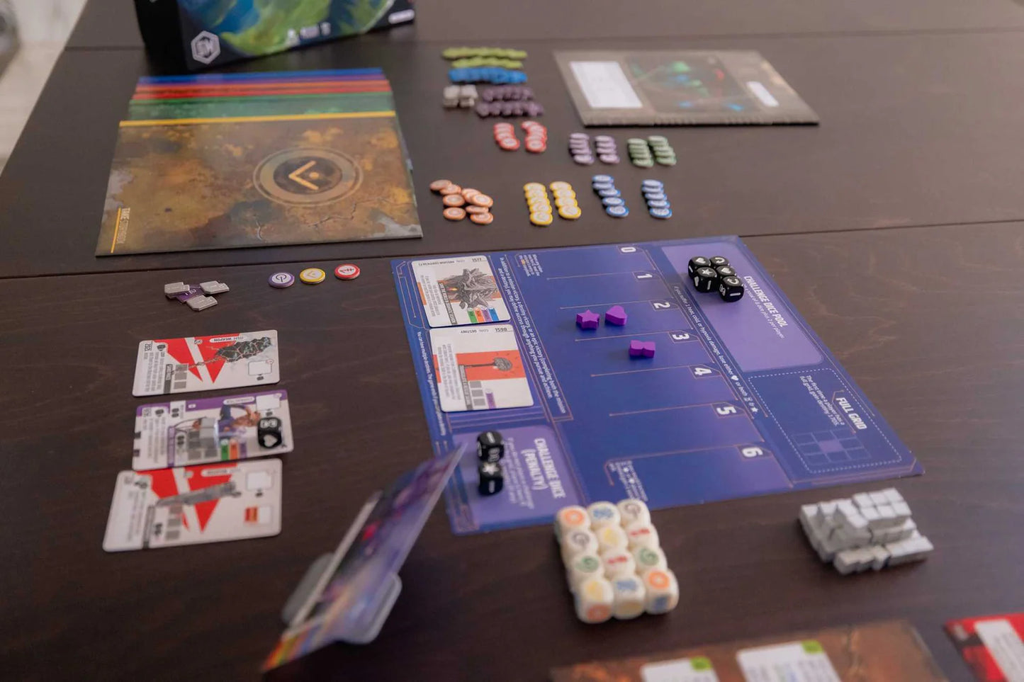 Board game setup with cards, pieces, and a board on a table
