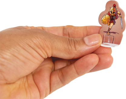 Hand holding a small figurine with a character on a white background