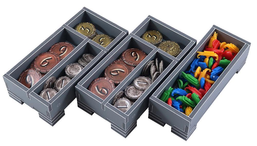 Set of gray compartments with coins and colorful items on a white background