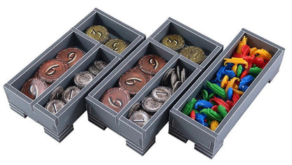 Set of gray compartments with coins and colorful items on a white background