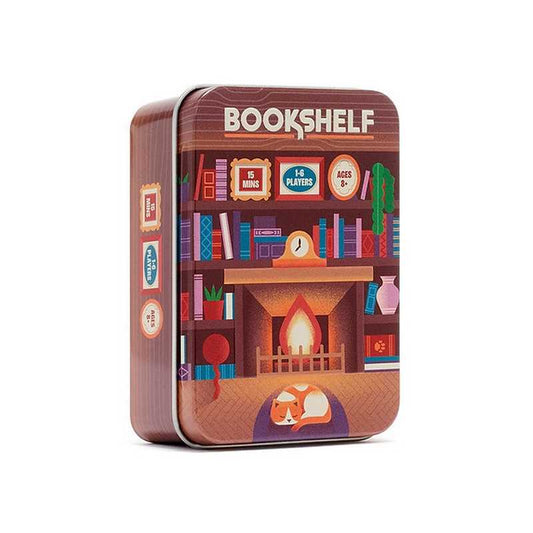 A square metal tin box for a game called BOOKSHELF, featuring a colorful illustration of a cozy bookshelf with a fireplace, books, and a sleeping fox on the front, shown on a plain white background.