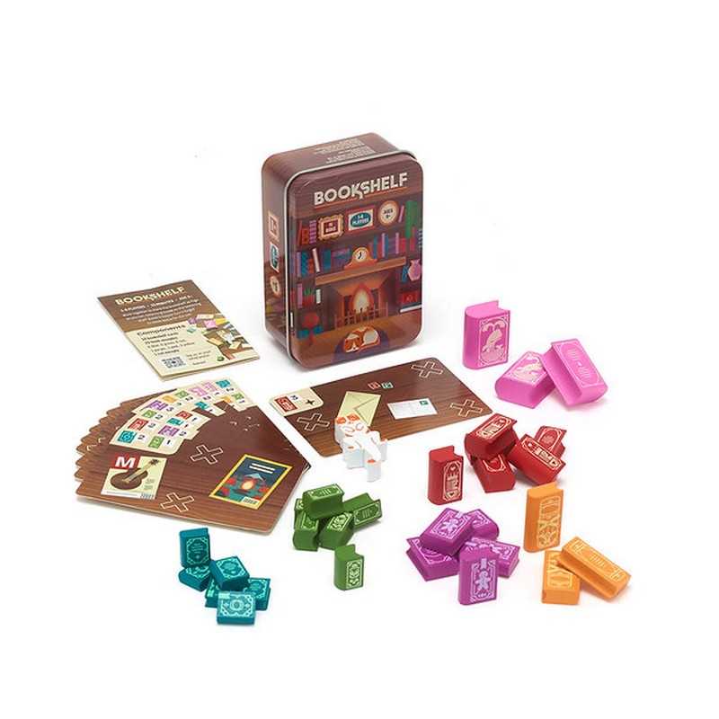 Board game components including cards, tiles, and a tin labeled 'Bookshelf' on a white background
