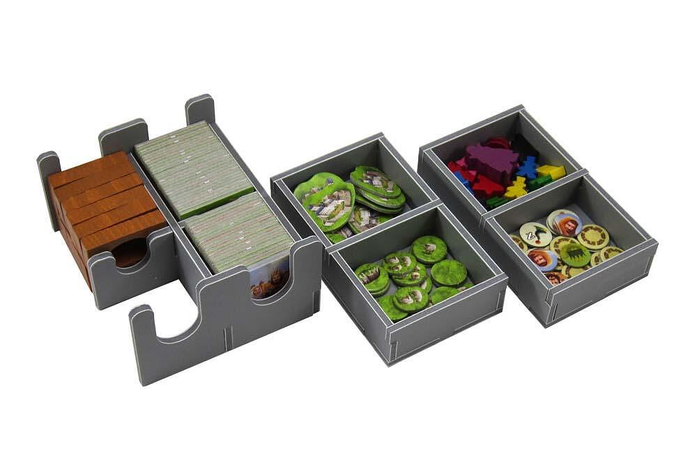Board game storage organizer with compartments for cards and game pieces on a white background