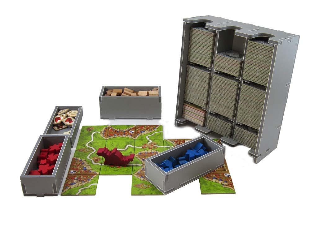 Board game components including cards, dice, and a map on a white background
