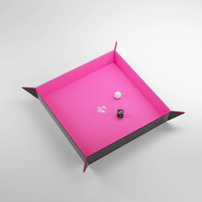 Pink and black dice tray with dice on a light gray background