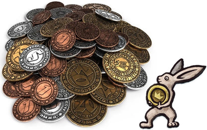 A pile of round fantasy-style coins in bronze, gold, silver, and copper tones, alongside a small embroidered bunny patch holding a gold coin, on a plain white background.