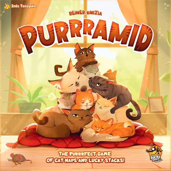 Board game cover of 'Purrramid' with cartoon cats on a red cushion.