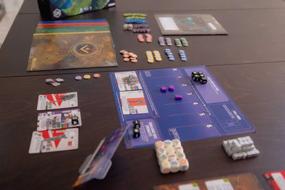 Board game setup with cards, pieces, and a board on a table