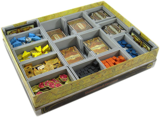 Board game components in a compartmentalized box on a white background