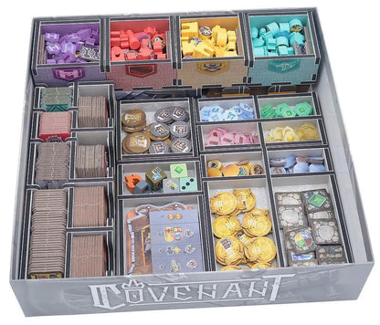 Board game organizer with compartments filled with various game pieces and cards labeled 'Covenants'.