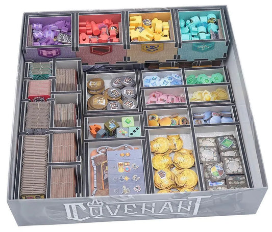 Board game organizer with compartments filled with various game pieces and cards labeled 'Covenants'.