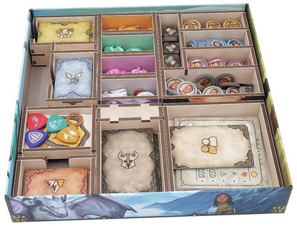 Board game box with compartments containing various game pieces and cards.