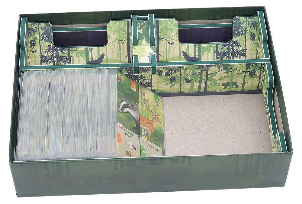 Card game box with forest-themed design and card compartments.