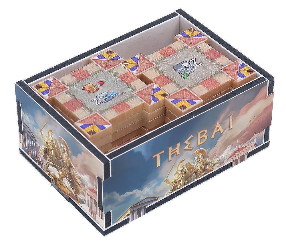 Board game box with 'Thebai' branding and game pieces inside
