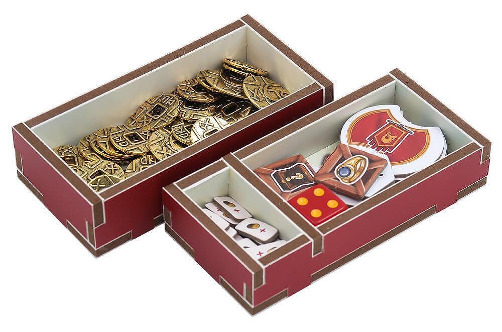 Decorative items including gold and red emblems in a box on a white background