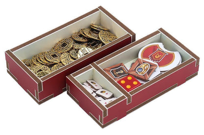 Decorative items including gold and red emblems in a box on a white background
